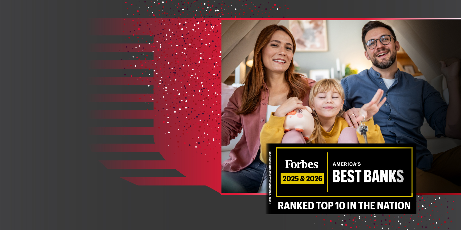 A family consisting of a woman, man, and child, in a cardboard box fort. The child is holding a piggybank and a set of keys.